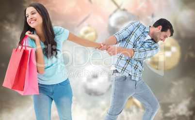 Composite image of happy couple with shopping bag