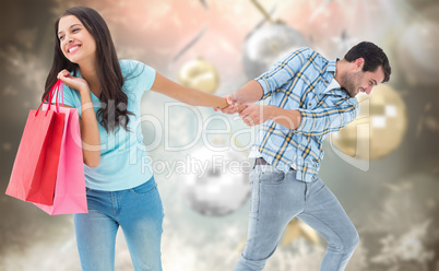 Composite image of happy couple with shopping bag Composite image of happy couple with shopping bag