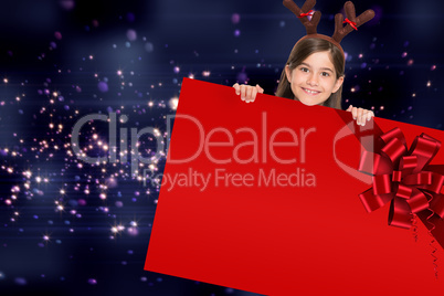 Festive girl showing card with red ribbon