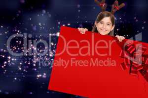 Festive girl showing card with red ribbon