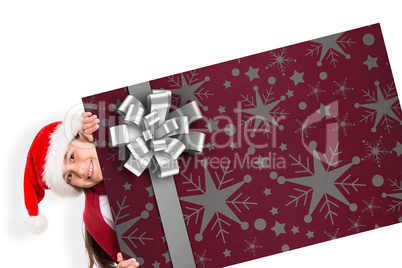 Composite image of festive little girl showing card