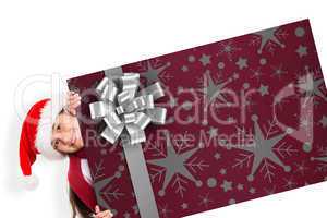 Composite image of festive little girl showing card