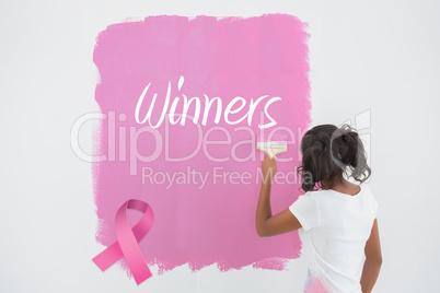 Composite image of young woman painting her wall in pink