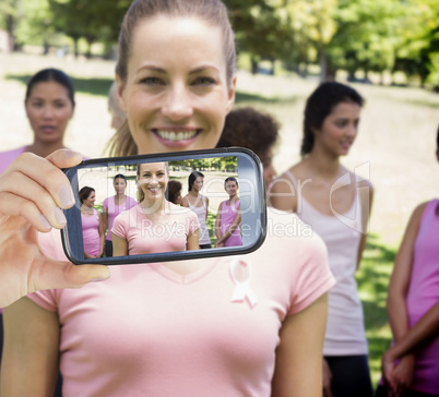 Composite image of hand holding smartphone showing