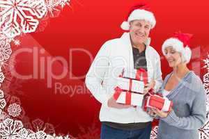 Composite image of festive mature couple holding christmas gifts