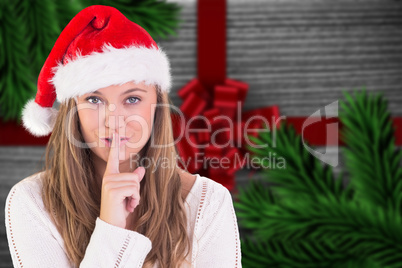 Composite image of festive blonde keeping a secret