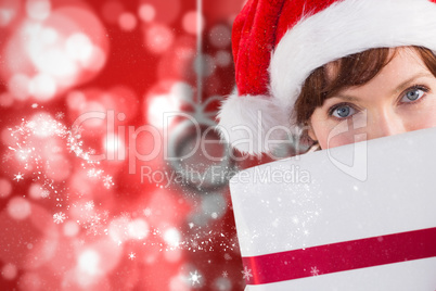 Composite image of woman holding a christmas present Composite image of woman holding a christmas present