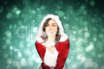 Composite image of pretty girl in santa outfit blowing