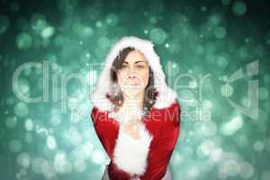 Composite image of pretty girl in santa outfit blowing