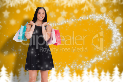 Composite image of woman walking with shopping bags