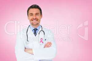 Composite image of handsome young doctor with arms crossed