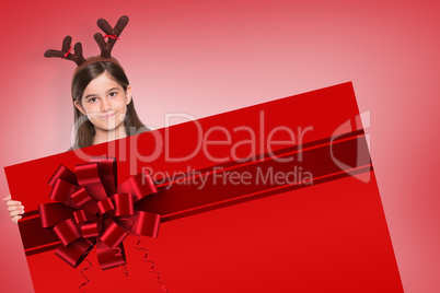 Composite image of festive little girl showing card