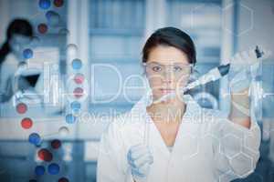 Composite image of serious chemist working with large pipette an