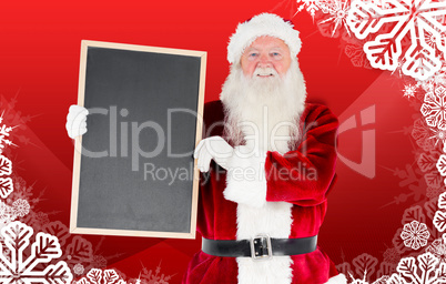 Composite image of santa claus showing blackboard