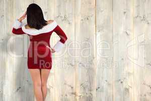 Composite image of rear view of sexy santa girl