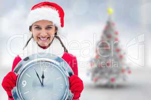 Composite image of festive brunette holding clock