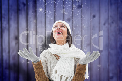 Composite image of brunette in warm clothing