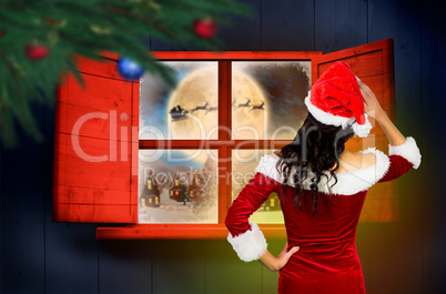 Composite image of rear view of sexy santa girl