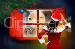 Composite image of rear view of sexy santa girl