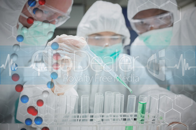 Composite image of chemist adding green liquid to test tubes as