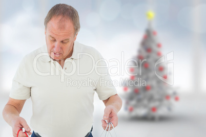 Composite image of man looking in shopping bags