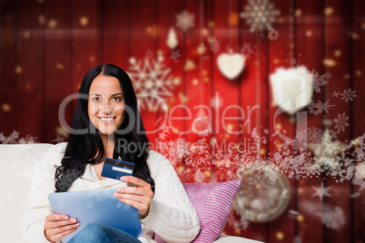 Composite image of woman sitting with tablet pc