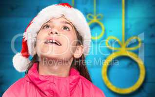 Composite image of festive little girl looking surprised