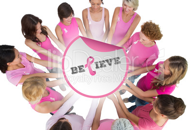 Composite image of cheerful women joined in a circle and looking