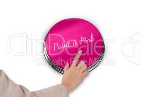 Hand pressing pink button for breast cancer awareness