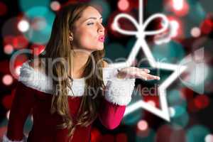 Composite image of sexy santa girl blowing a kiss