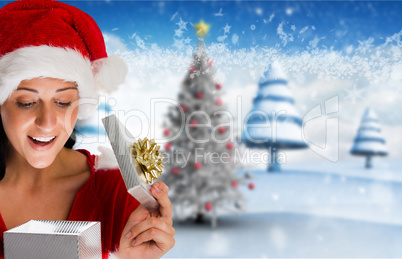 Composite image of smiling woman opening christmas present