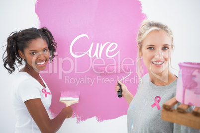 Composite image of smiling housemates painting wall pink