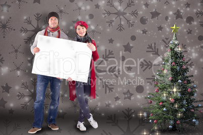 Couple holding a large sign together