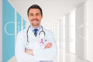 Composite image of handsome young doctor with arms crossed