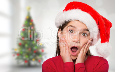 Composite image of festive little girl looking surprised