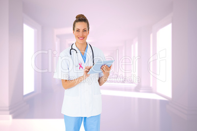 Composite image of pretty nurse using tablet pc