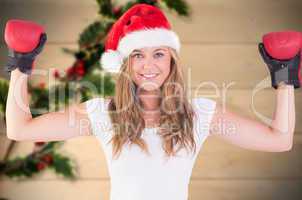 Composite image of festive blonde with boxing gloves