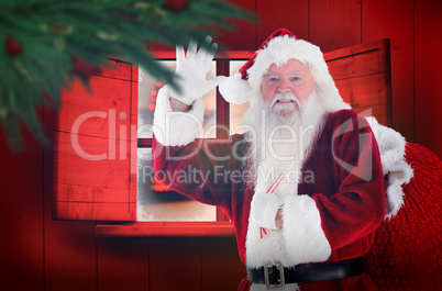 Composite image of santa claus waving