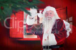 Composite image of santa claus waving