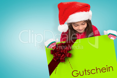 Composite image of festive little girl showing card