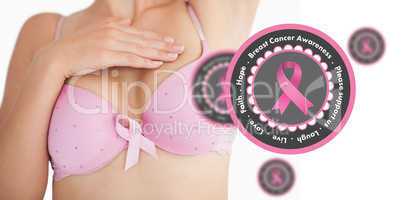 Composite image of woman in bra with breast cancer awareness rib