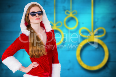 Composite image of cool santa girl wearing sunglasses