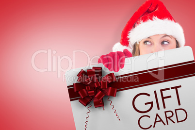 Composite image of festive blonde holding a poster