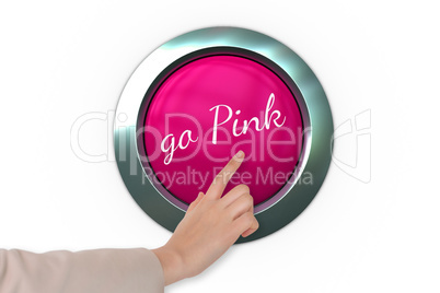 Hand pressing pink button for breast cancer awareness