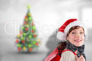 Composite image of smiling woman wearing santa hat