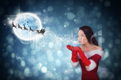 Composite image of pretty girl in santa outfit blowing