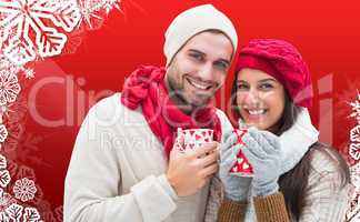 Composite image of winter couple holding mugs