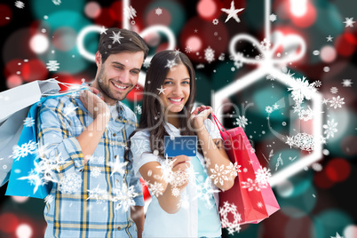 Composite image of couple with shopping bags and credit card