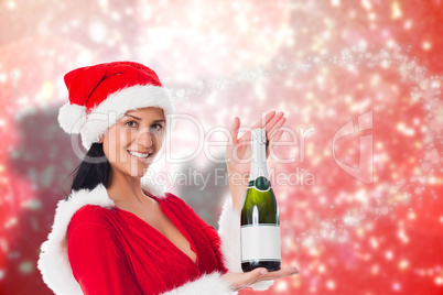 Composite image of woman holding a champagne bottle