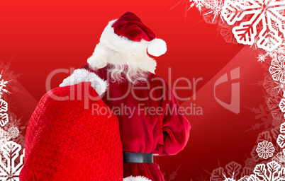 Composite image of santa claus carrying sack